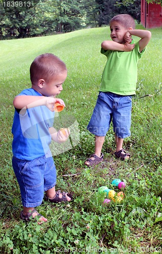 Image of Two babies with pile of Easter eggs