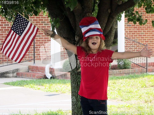 Image of Pretty girl in 4th of July hat and flag