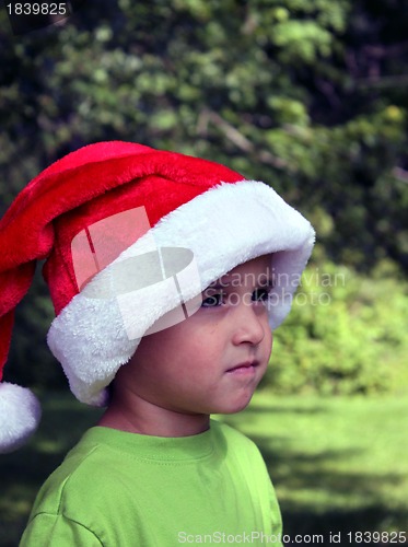 Image of Boy in green shirt and santa hat