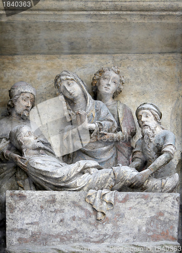 Image of Jesus is laid in the tomb and covered in incense