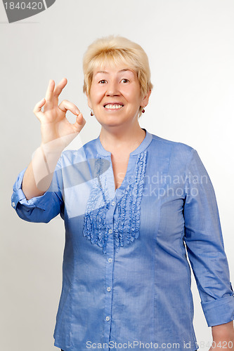 Image of Middle-aged woman shows OK