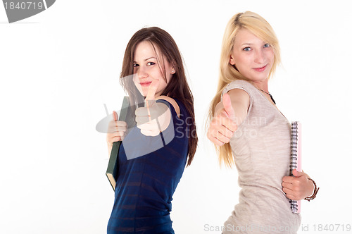 Image of Two beautiful student girls showing thumbs up