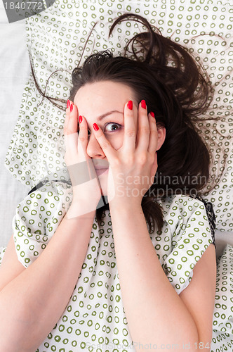 Image of Young woman in the bed