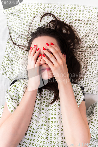 Image of Young woman in the bed