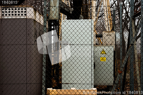 Image of Electric boxes behind fence