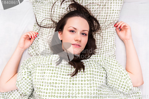 Image of Young woman in the bed