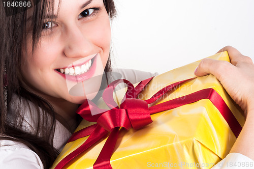 Image of Young woman with christmas present