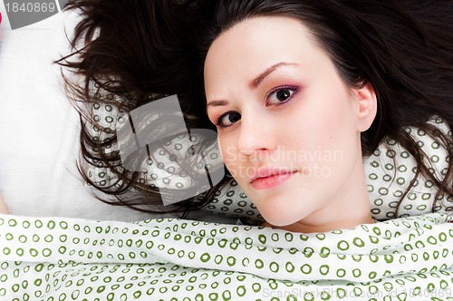 Image of Young woman in the bed