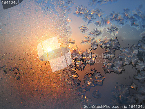 Image of Ice pattern and sunlight on winter glass