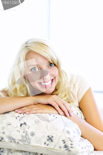 Image of Happy woman on couch at home