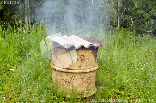 Image of Smoke rises rusty smokehouse asbestine slate roof 