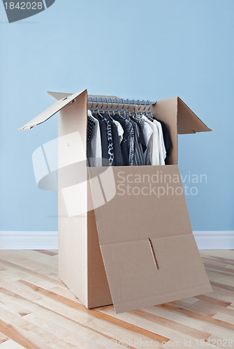 Image of Wardrobe box with clothing, ready for moving