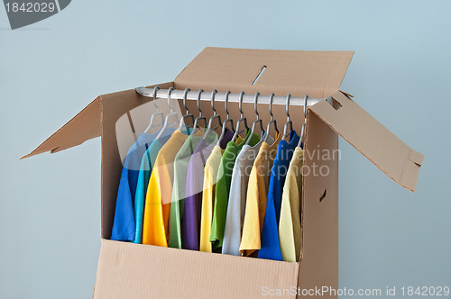 Image of Colorful clothing in a wardrobe box for easy moving