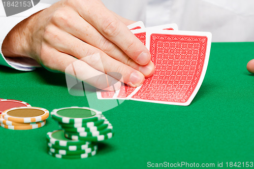 Image of Man with cards on a gambling table