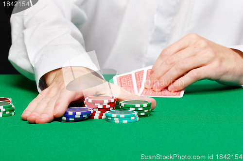 Image of Man with cards on a gambling table