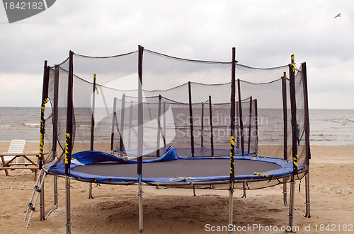 Image of Trampolines on beach sea sand. Active recreation. 