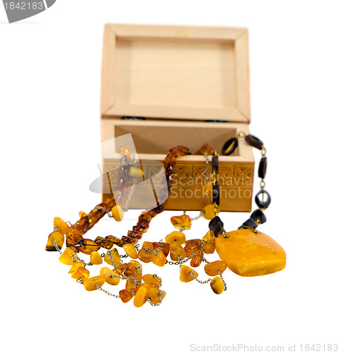 Image of Amber jewelry and wooden box isolated on white 