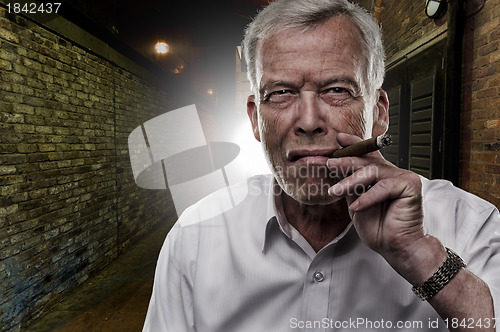 Image of Senior man smoking a cigar