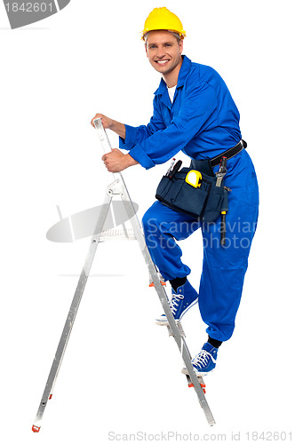 Image of Repairman climbing up a stepladder