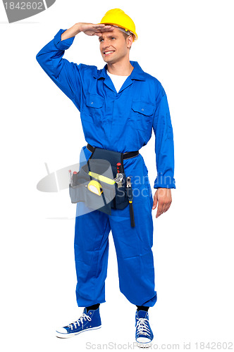 Image of Repairman looking forward shielding hand