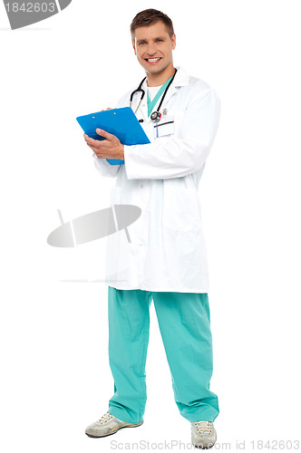 Image of Portrait of smiling doctor holding clipboard