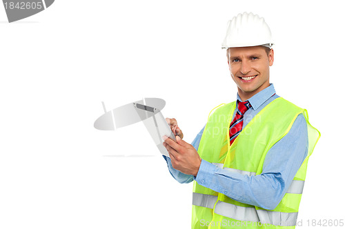 Image of Construction engineer operating wireless device