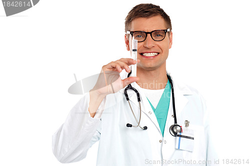 Image of Doctor with an injection needle with white fluid