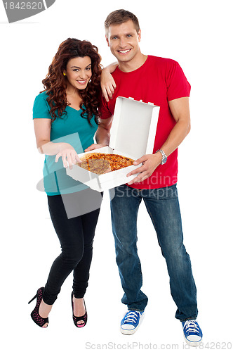 Image of Young couple about to enjoy pizza together