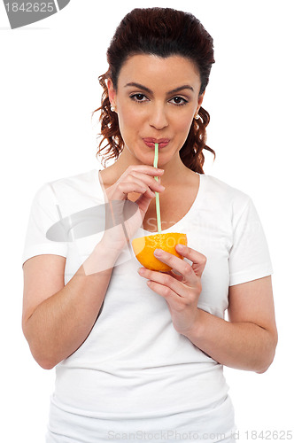 Image of Active fit girl drinking fresh orange juice