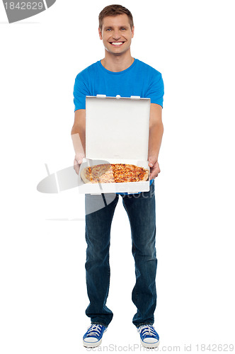Image of Casual guy showing freshly baked yummy pizza
