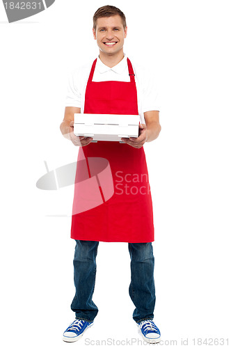 Image of Full length portrait of male chef holding pie box