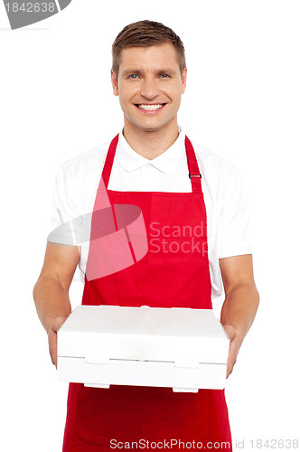 Image of A chef in red uniform offering you a pizza box
