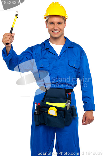 Image of Smiling young repairman holding hammer