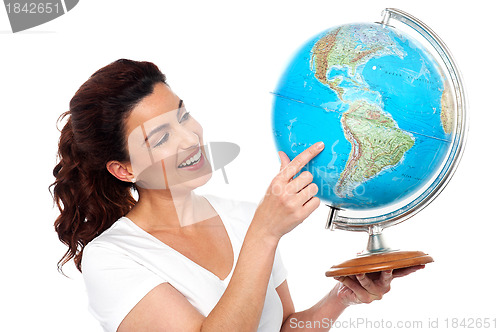 Image of Woman holding globe in her hand