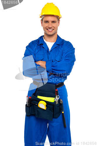 Image of Young industrial contractor posing with crossed arms