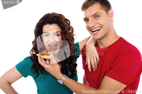 Image of Boyfriend making her girl eat hot pizza piece
