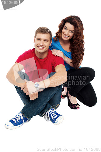 Image of Attractive love couple sitting relaxed on floor