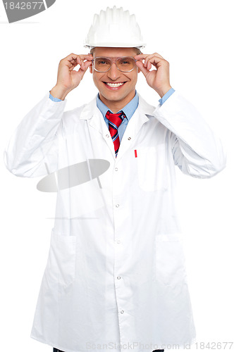 Image of Smiling architect holding eyeglasses