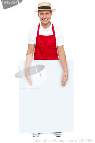 Image of Male chef presenting you blank advertising board