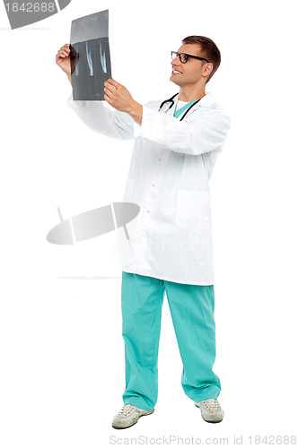 Image of Handsome surgeon looking on patient