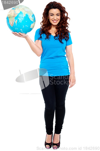 Image of Stylish trendy girl posing with globe in hand