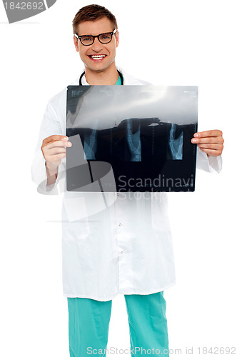 Image of Happy young surgeon showing x-ray of a patient