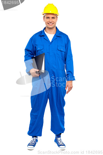 Image of Industrial worker posing with a file folder