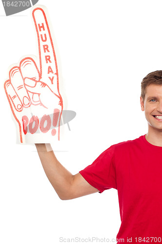 Image of Cropped image of a casual guy with big foam hand