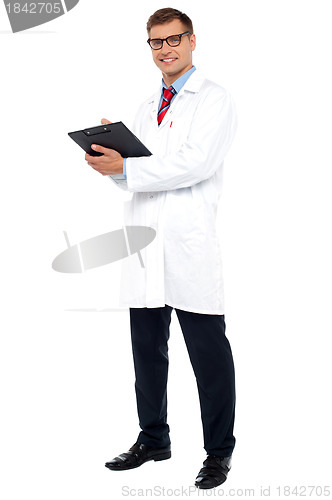 Image of Full length shot of physician posing with clipboard