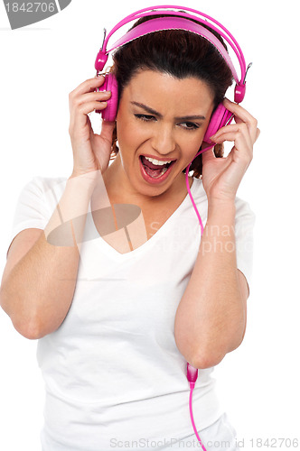 Image of Brunette women enjoying rocking with loud music