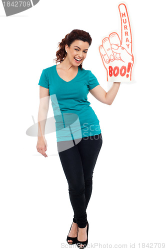 Image of Woman cheering with large boo hurray foam hand