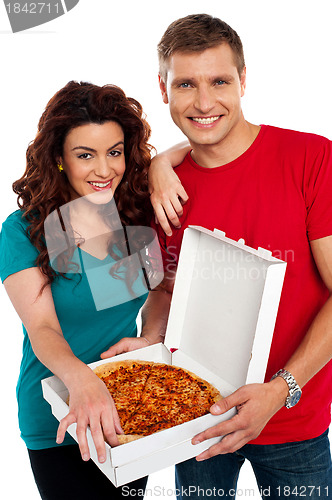 Image of Cheerful love couple enjoying pizza together