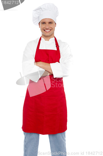 Image of Confident cheerful male chef with arms crossed