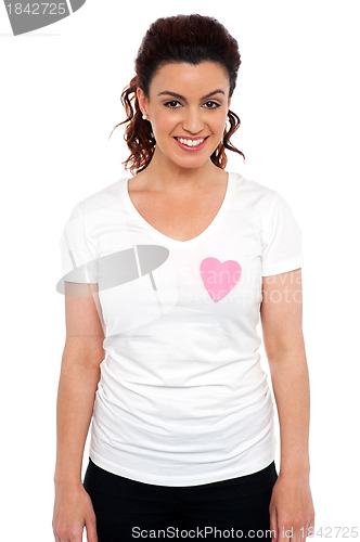 Image of Woman with pink paper heart on her t-shirt